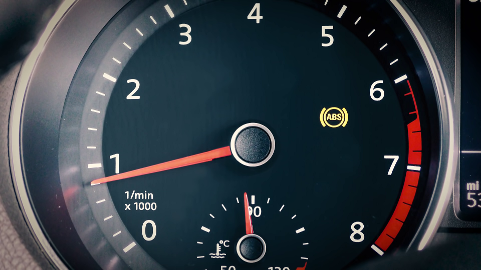 An image showing the ABS (Anti-Lock Braking System) warning light lighting up on the dashboard to indicate a problem with the ABS.