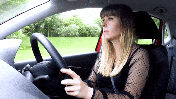 A gif image of a female student driver setting the rear demister on and then off.